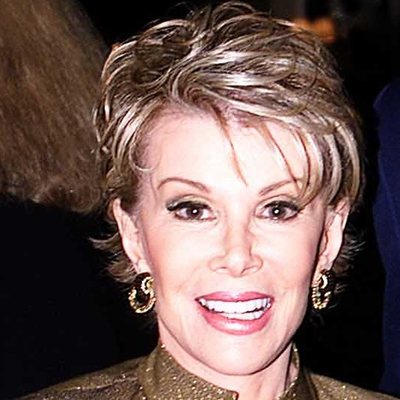 Joan Rivers, smiling, in a gold jacket, at a USO event in New York in 2001. Cropped. Not from the 2014 remark.