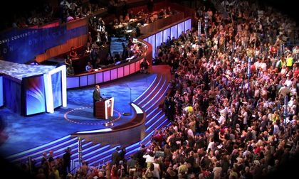 Verified real photograph: a wide view of the stage and hall at the 2008 Democratic National Convention, where Craig Robinson introduced his sister. He is small in the frame.